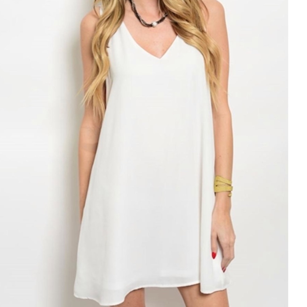 White romper with adjustable straps.